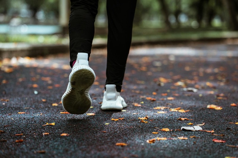 Runner mid-stride on an autumn path